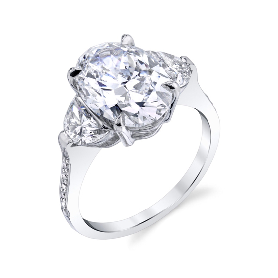 Oval brilliant diamond with two half moon brilliant cut diamonds in a platinum ring